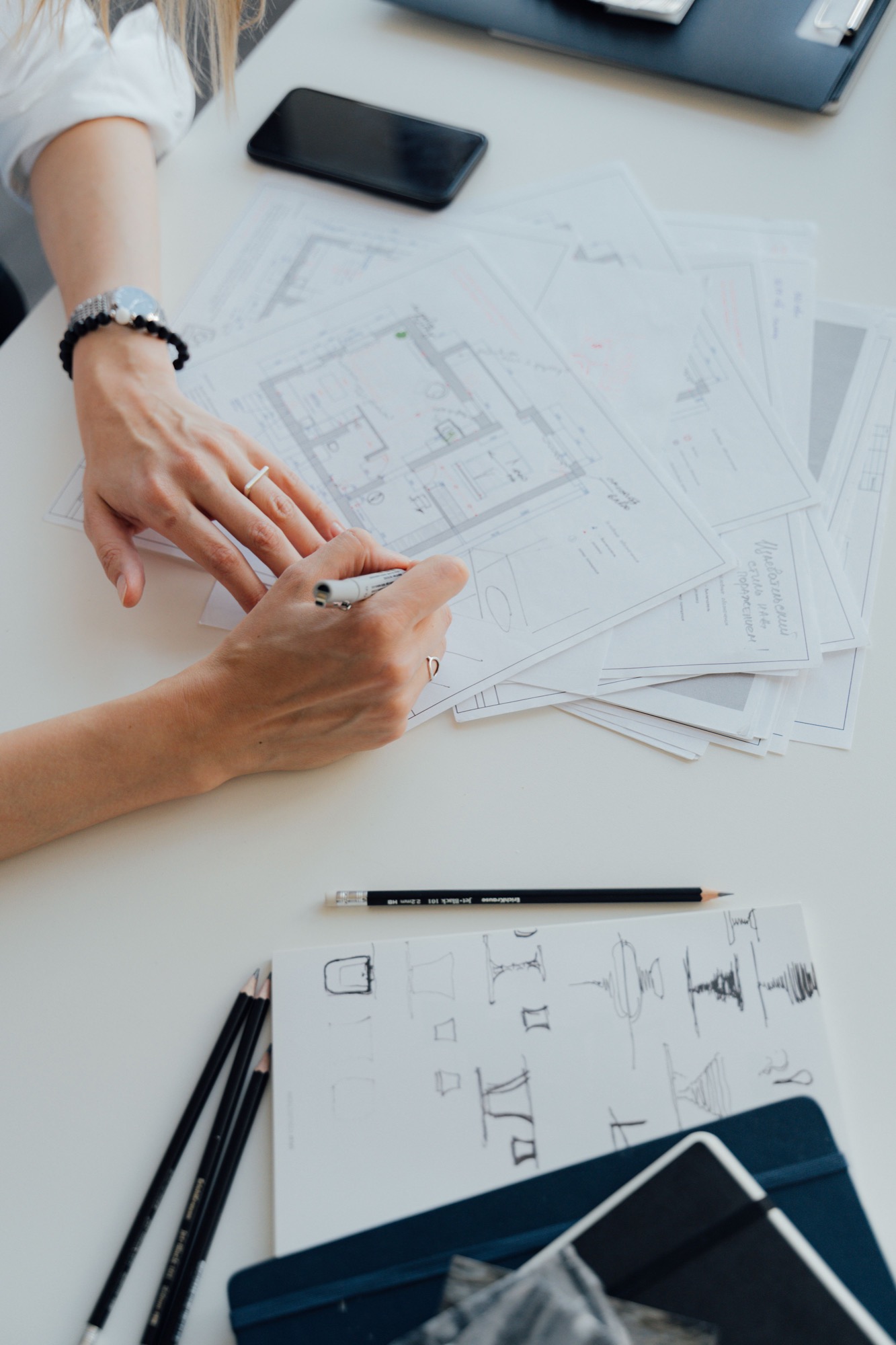 An architect translating ideas into precise marks on a set of working plans